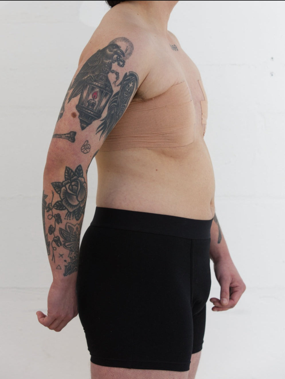 Model from the side wearing size M black packing boxer and soft-form packer