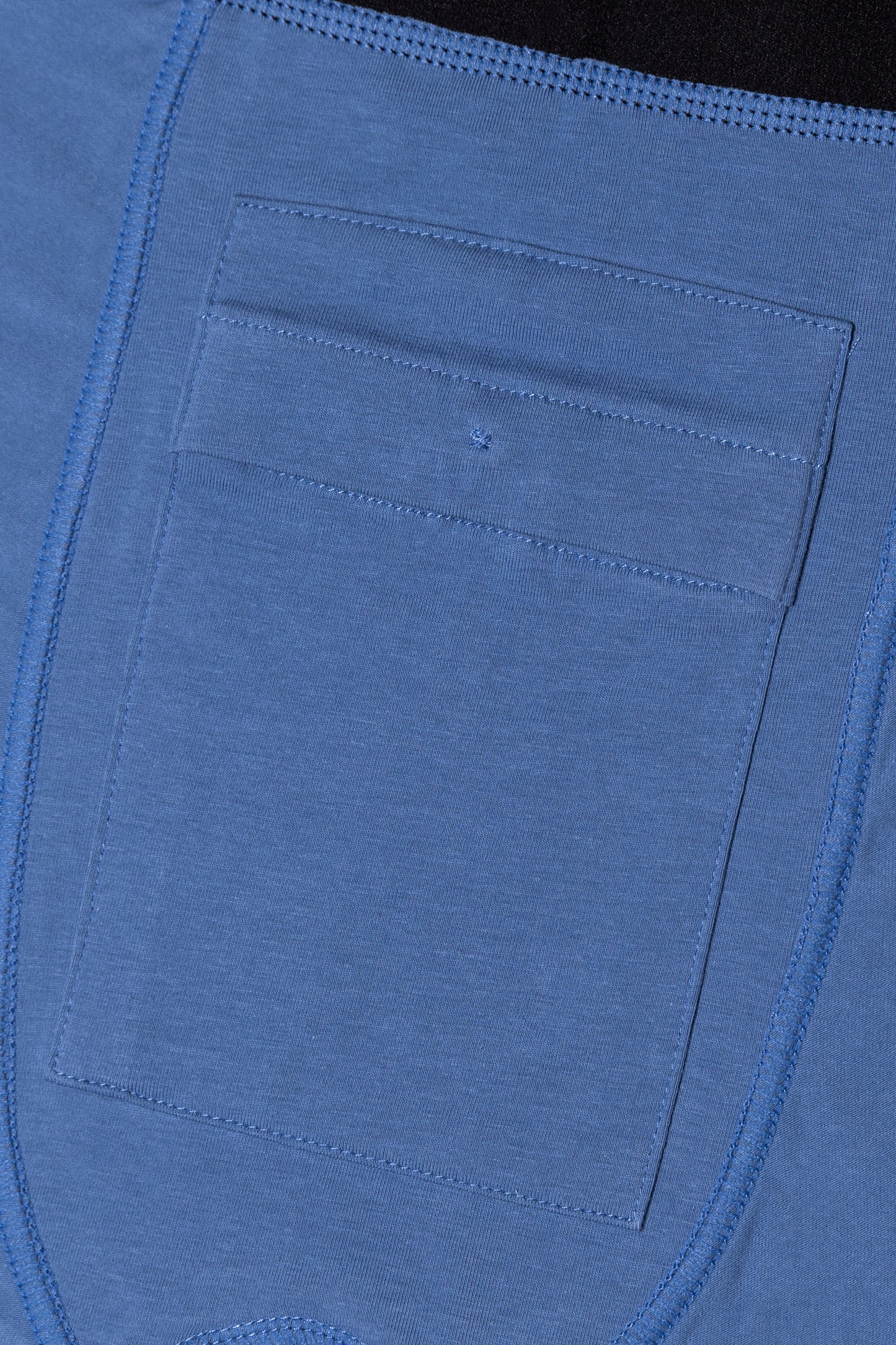 Close-up of a blue fabric pocket discreetly inside blue packing boxers with stitching details
