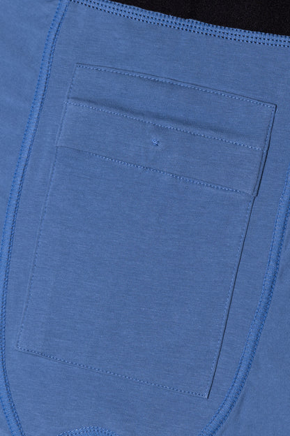 Close-up of a blue fabric pocket discreetly inside blue packing boxers with stitching details