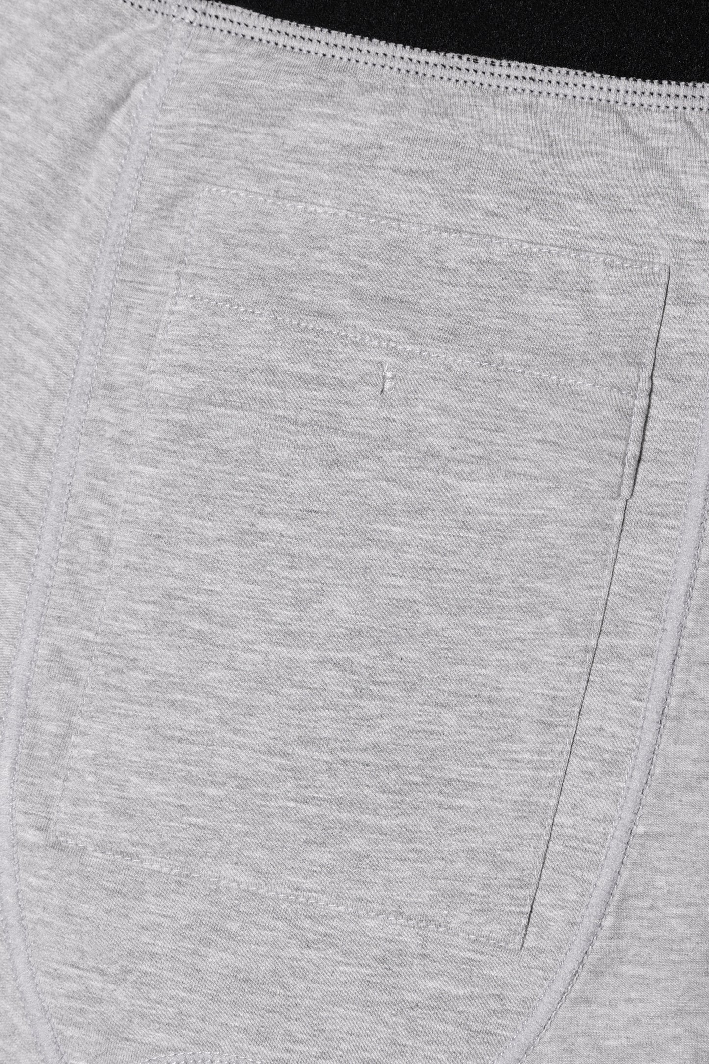 Close-up of the discreet grey fabric pocket detail