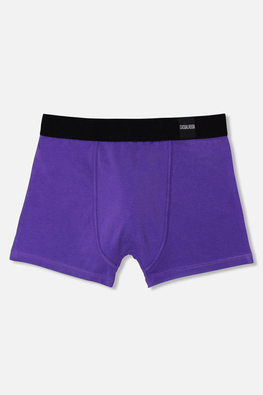 Purple packing boxer brief with black waistband on a light gray background