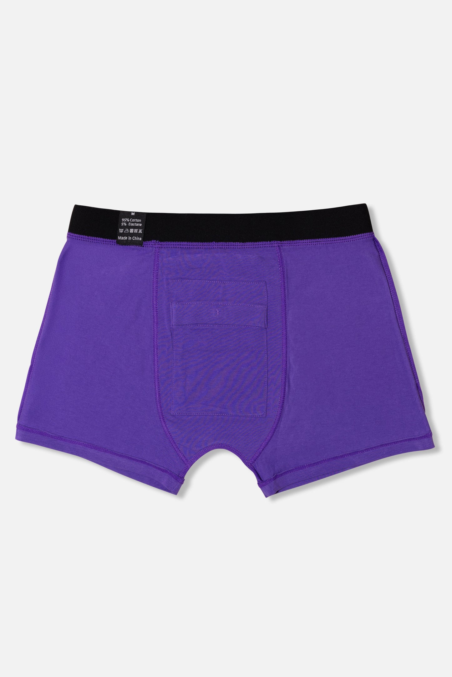 Inside of purple packing boxer briefs with black waistband on a light gray background