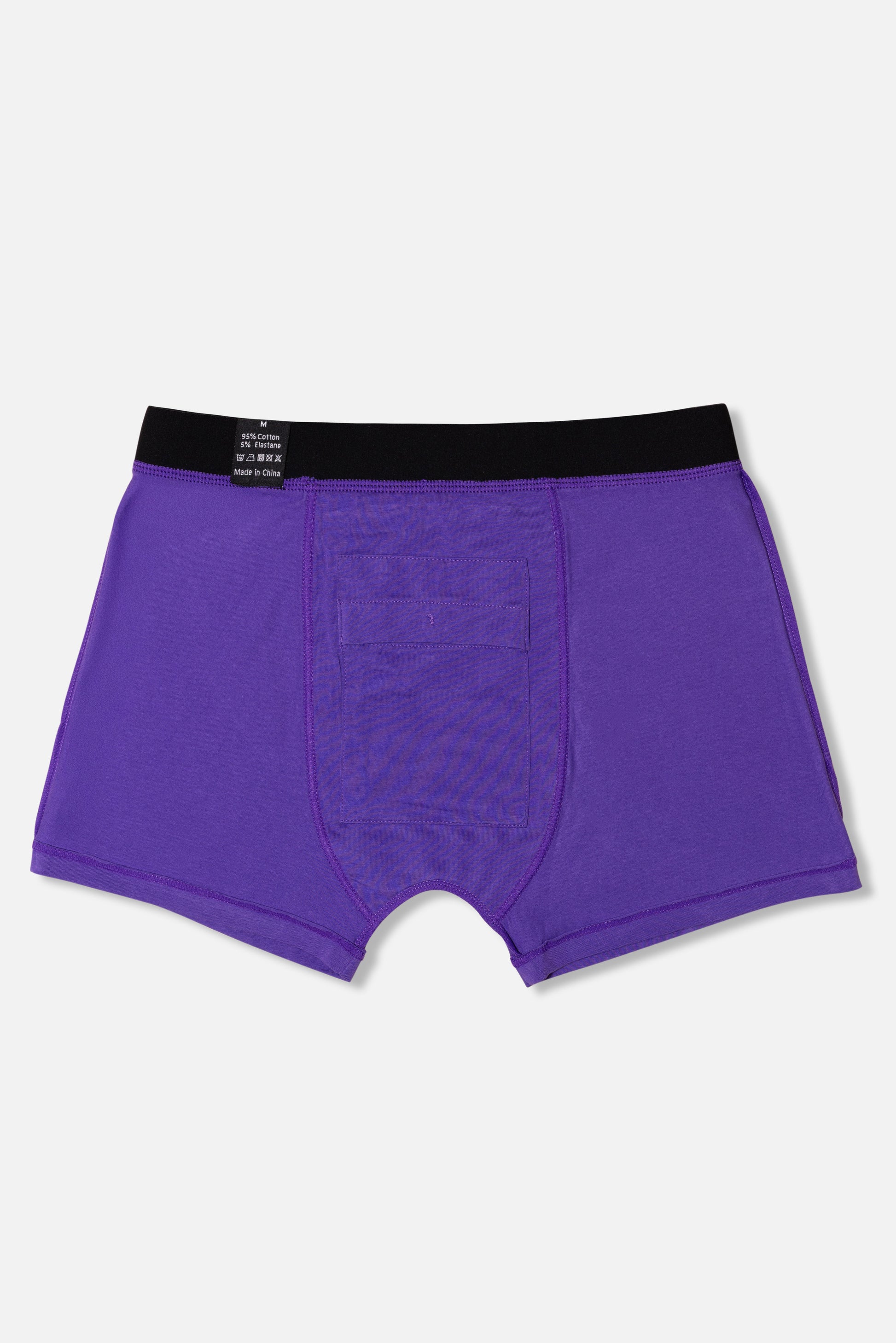 Inside of purple packing boxer briefs with black waistband on a light gray background