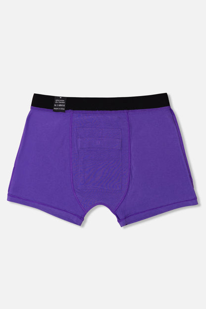 Inside of purple packing boxer briefs with black waistband on a light gray background