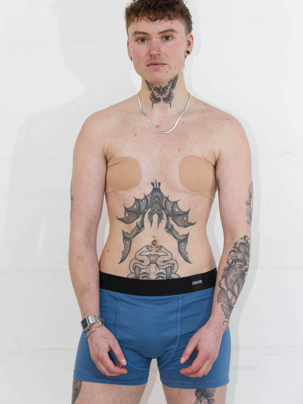 Person wearing size M blue packing boxers with soft-form packer in front of white background