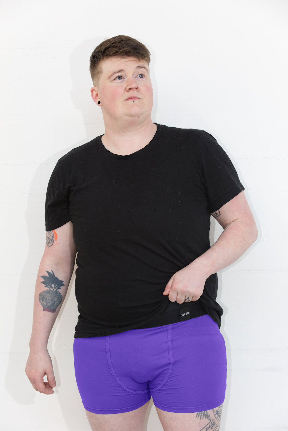 Person wearing size L purple packing boxer brief with a black t-shirt. Standing infront of a white background.