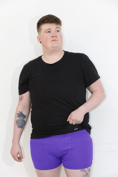 Person wearing size L purple packing boxer brief with a black t-shirt. Standing infront of a white background.