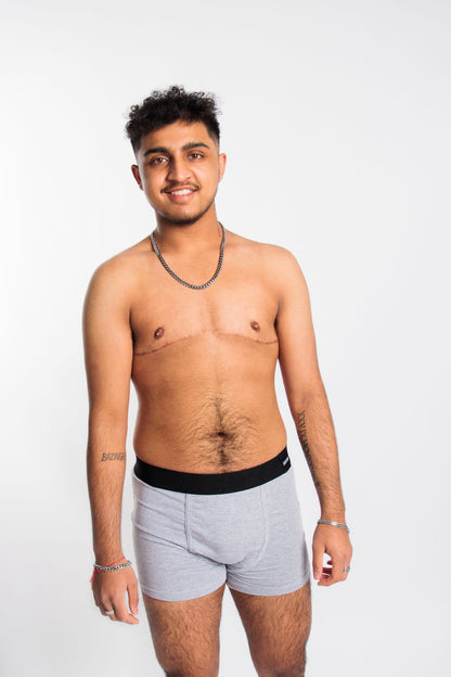 Person wearing grey packing boxers and soft-form packer in front of a white background.